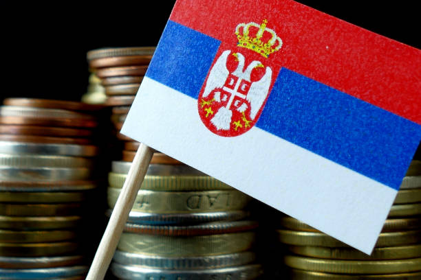 istock Serbia flag waving with stack of money coins macro 641660112