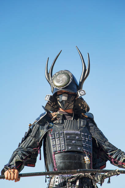 Kyoto, Japan - October 22, 2012: Geisha dressed up asTomoe Gozen at the Jidai Matsuri festival . Also called the Festival of Ages it is a traditional festival celebrated every 22 of October since 1895 to conmemorate the  anniversary of the foundation of Kyoto. It is a large parade with over two thousand people dressed in accurate costumes of the japanese history that spans 1100 years when Kyoto was Japan capital and also represents well important historic figures of the past. The parade goes from the Imperial Palace to the Heian Shrine. Tomoe Gozen is one of the few women samurais or onna bugueisha that existed known for her bravery. She fought on the Genpei wars in the XII century.  Geishas and maikos take an important role in the festival when they dress up and take the role of important characters of the past.