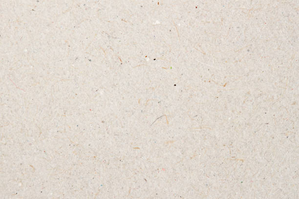 istock Paper texture cardboard background for design with copy space text or image. Recyclable material that looks virtually identical to the plain , but has small inclusions of cellulose 641670158