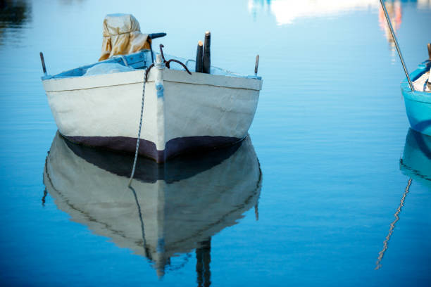istock Boat on lake with a reflection in the water at sunrise 641670884