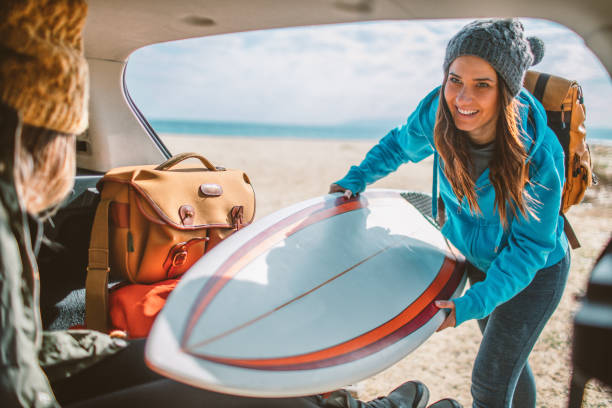 surfers on the road trip - women sea cheerful surfing imagens e fotografias de stock