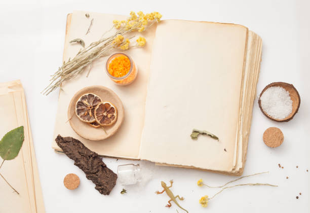 istock old book and a bunch of dried herbs 641674148