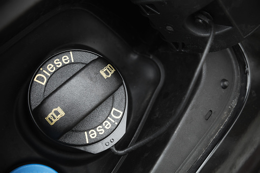 Modern car details, closed fuel cap with Diesel text marking. Close-up photo with selective focus