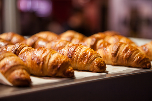 Rows of fresh baked French croissants ready to be sold