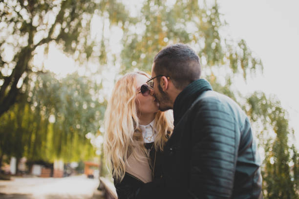 istock Couple kissing in park 641680600