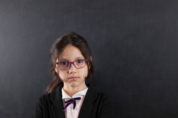 istock schoolgirl in front of blackboard 641681316