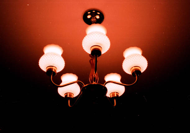 Ceiling lamp fading into blackness stock photo