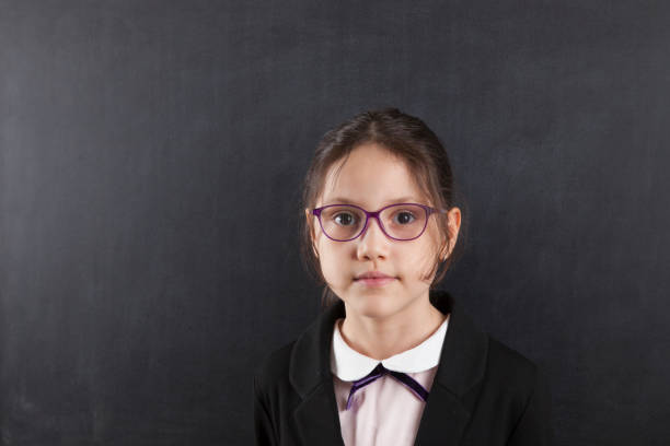 istock schoolgirl in front of blackboard 641682078