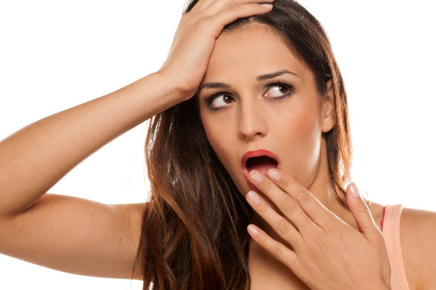 istock shocked young woman on white background 641682710