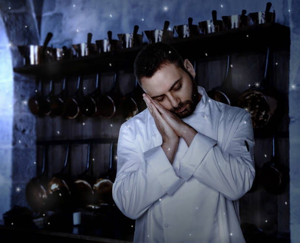 Chef sleeping in the kitchen at night.