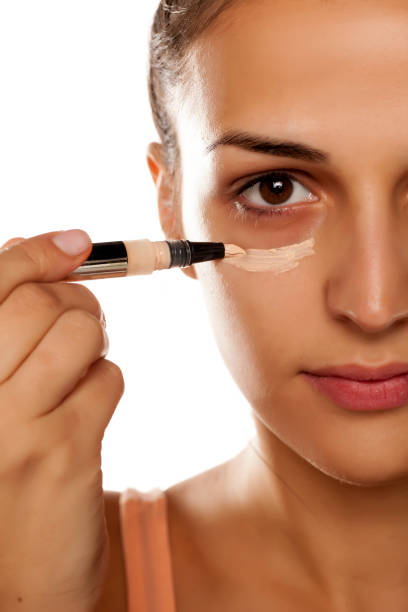 istock young woman applied concealer on her eye circles 641684690