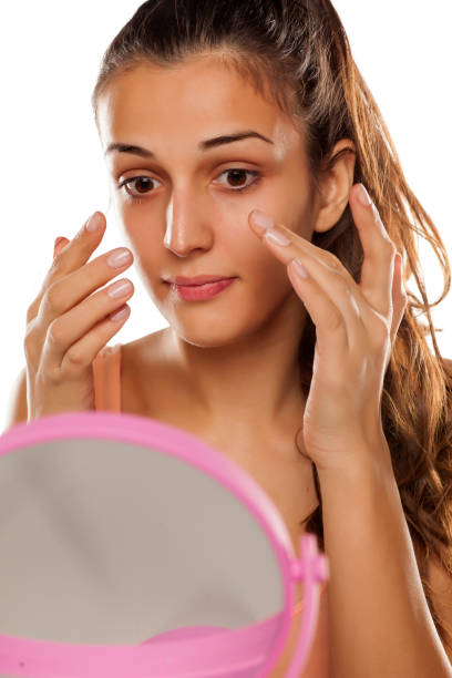 istock young beautiful woman applied protective cream on her face 641684698
