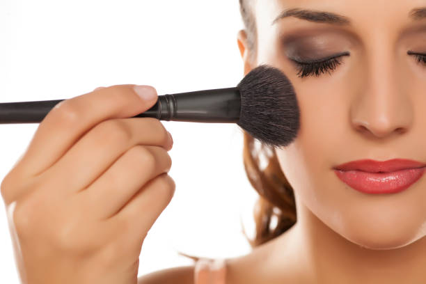 istock young woman applied blush on her cheeks 641684738