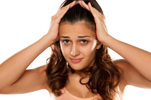 istock young woman with headache 641684774
