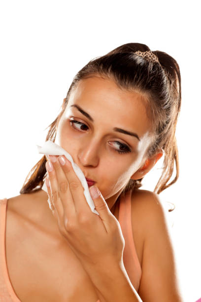 istock young beautiful woman remove her make-up with wet wipes 641684780