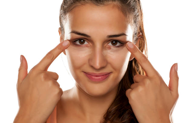 istock young woman applied concealer on her eye circles 641684798