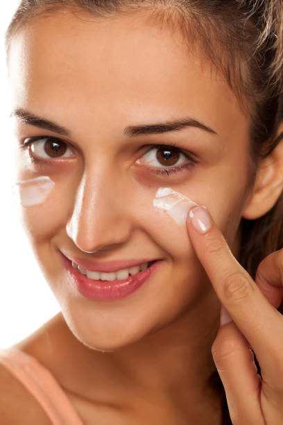 istock young beautiful woman applied protective cream on her face 641684830