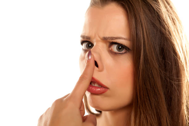 istock young unhappy woman raised her nose on white background 641684892