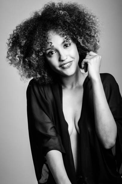 istock Young black woman with afro hairstyle laughing. 641686166