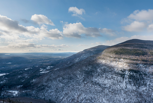 Catskill mountains including Plattekill Mountain in the foreground covered in snow overlooking New York's Hudson Valley
