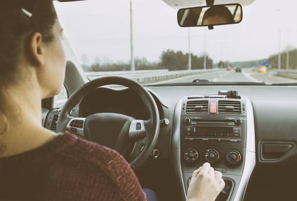 istock Young woman driving car on highway 641689456