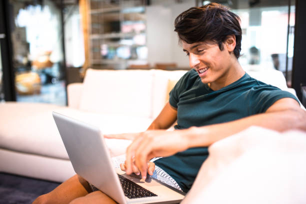 istock man surfing on the coach and buying on the web 641690104