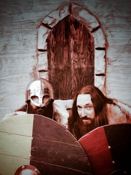 Old Norse Viking Warrior Authentic Pelt Period Costume Bearded Man. Viking warriors were nomads known for their brutal attacks and weapon of choice, the battle axe. Shields are modeled after traditional viking shields in yellow and black and red and black.