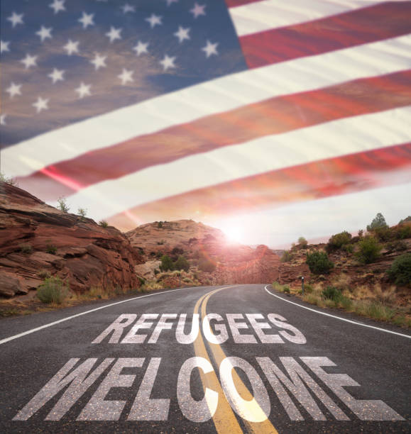 istock Empty Road with REFUGEES WELCOME text and USA flag 641703626