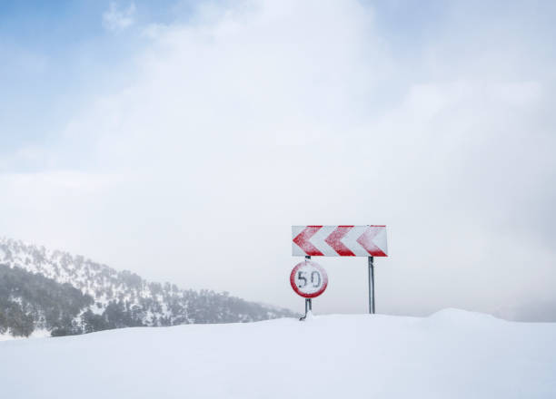 istock Frozen and snowed guide road signs 641704050