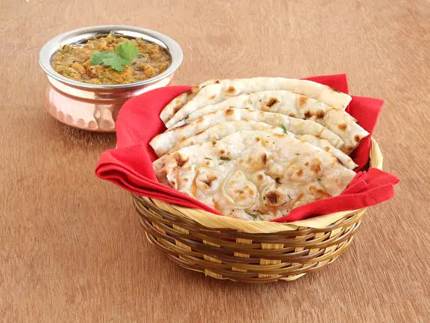Indian food kulcha, a type of traditional and popular bread, and vegetable curries.