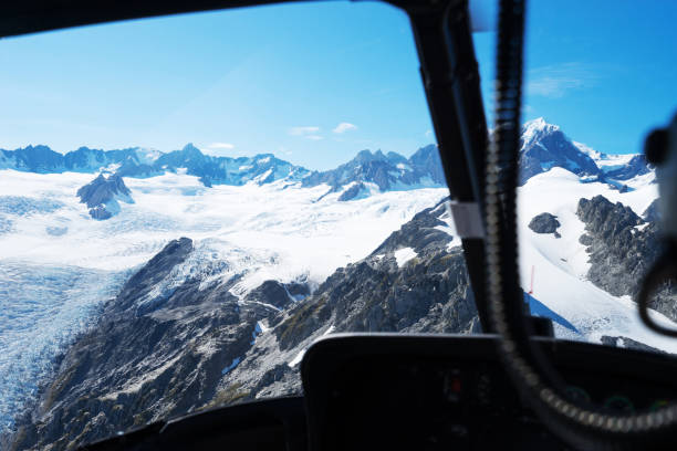 istock beautiful snow moutain from flying helicopter window 641708250
