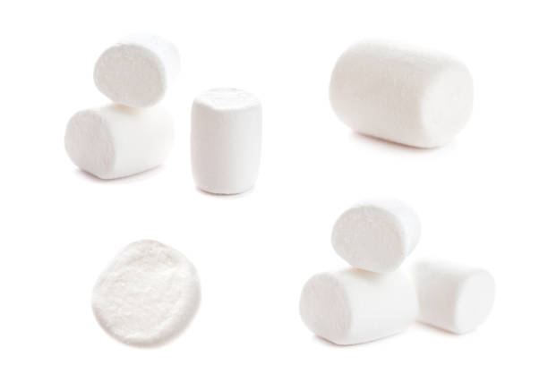 Fluffy white marshmallow macro isolated over white background. Heap of white marshmallows