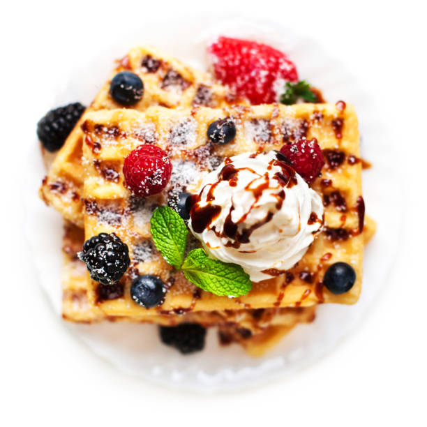 istock Belgian waffles with fresh berries and cream  isolated on white background 641711322