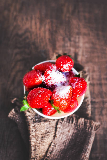istock red strawberries on wooden table. Fresh strawberries in a bowl with copy space 641711426
