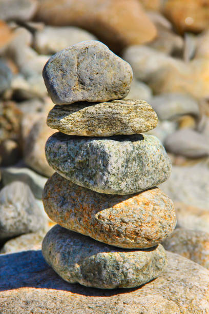 istock pebbles tower in the river bank closeup 641712190