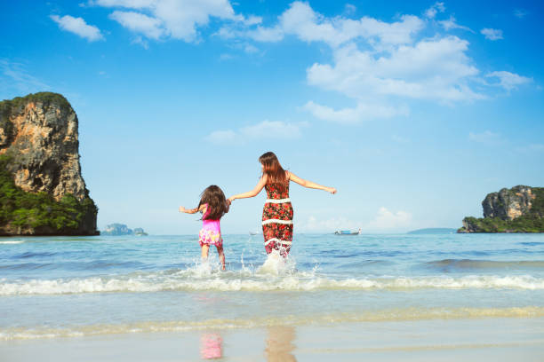 Happy mother and young daughter on the beach