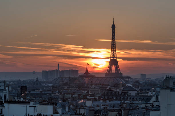 istock PARIS, 4 December 2016 - Beautiful red sunset sky casting on the illuminated Eiffel tower and the roofs of Paris, France 641715268
