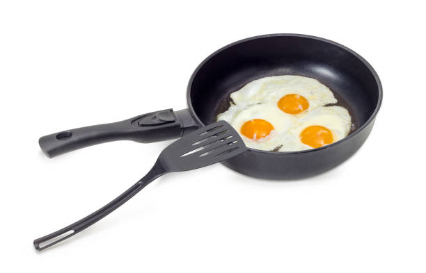 istock Three fried eggs in the frying pan and spatula 641715892