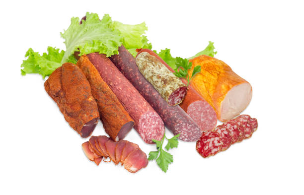 diversi prodotti a base di carne cotta con verdure su sfondo chiaro - sausage horse meat salami foto e immagini stock
