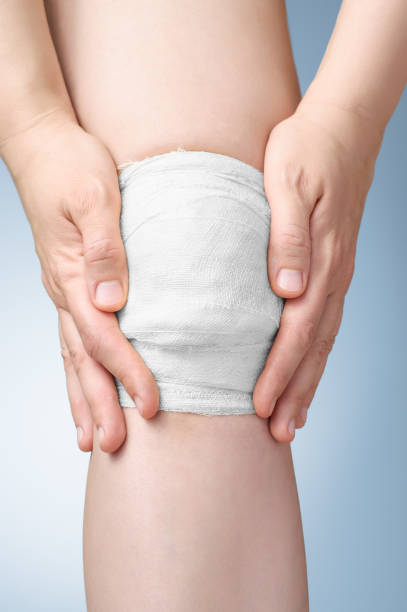 istock Injured knee with bandage 641717620