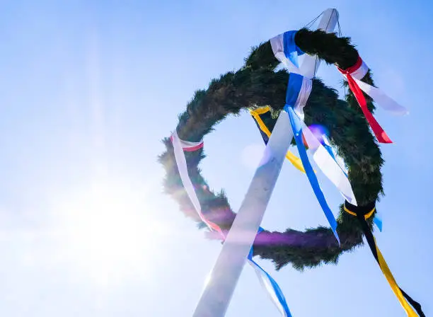 typical bavarian maypole in front of blue sky