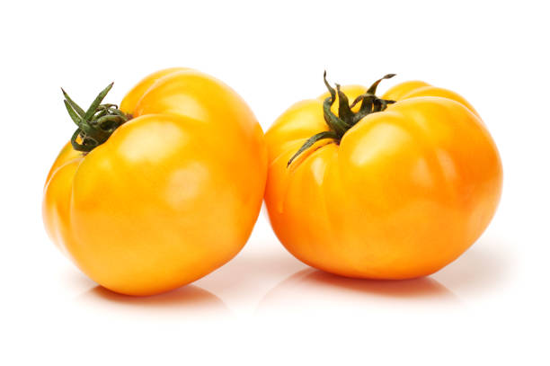 istock Home grown yellow tomatoes  closeup isolated on white background. With clipping path 641720884