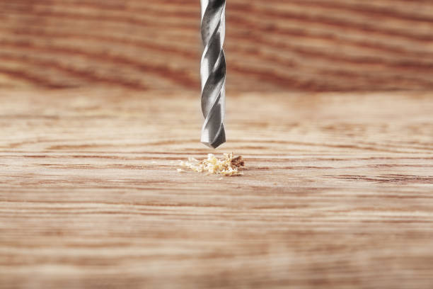 istock metal drill bit make holes in wooden board with expressive texture 641723624
