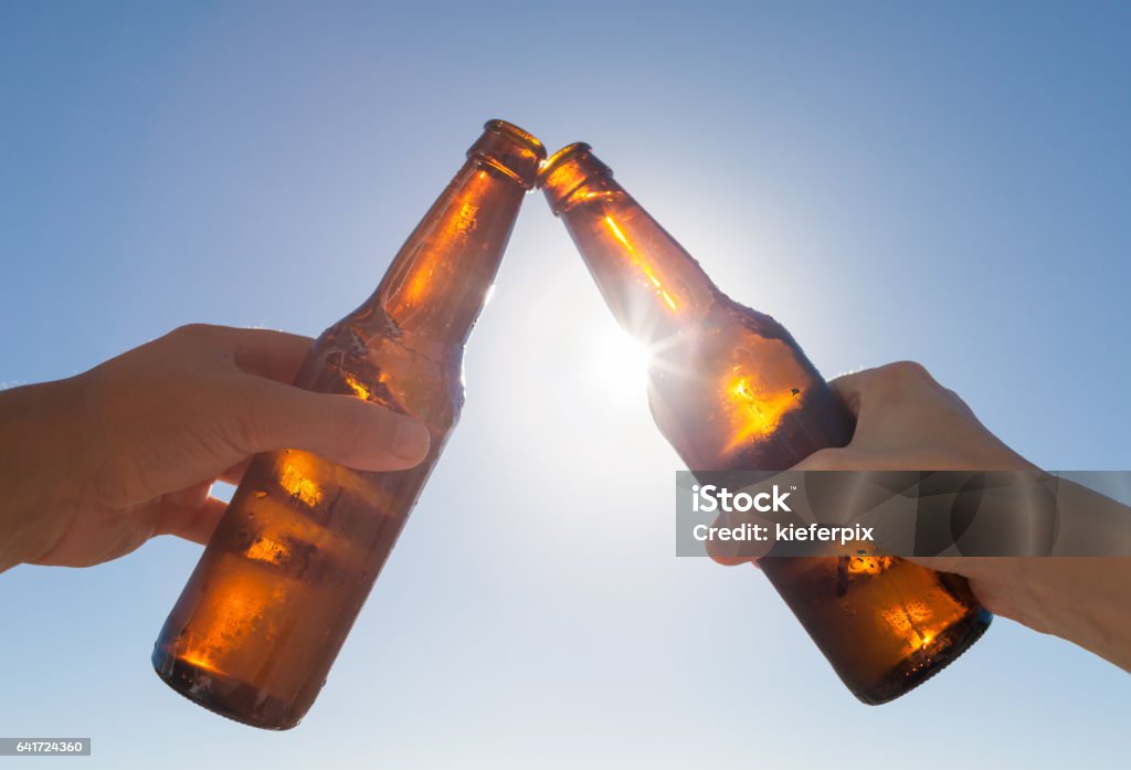 Cheers to beer! Friends toasting with beer. Celebratory Toast Stock Photo