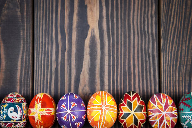 istock Easter eggs in a row on dark wooden background. 641725060