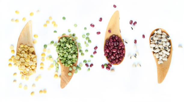 Grains beans with wooden spoon on white background Grains beans with wooden spoon on white background, top view organic red cowpea beans stock pictures, royalty-free photos & images