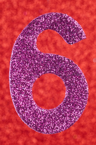 istock Number six purple color over a red background. Anniversary. 641728434
