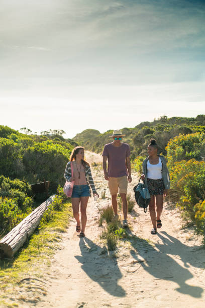 istock Young friends walking on dirt road 641730814