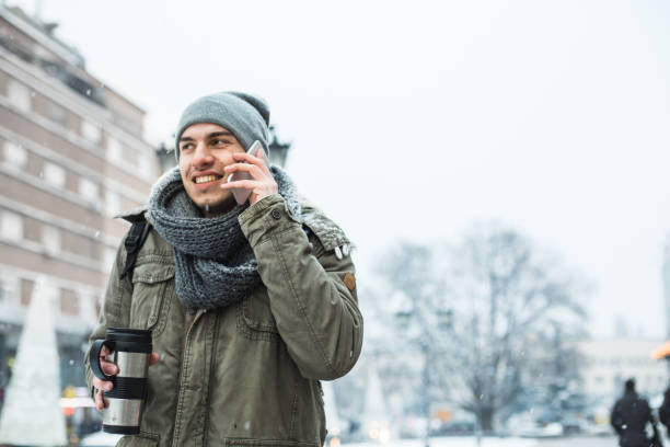 istock Young man talking on cellphone on the street 641730912
