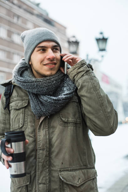 istock Young man talking on cellphone on the street 641730922